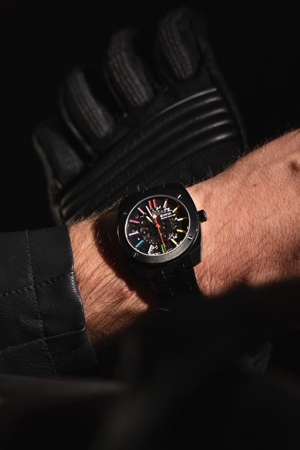 lifestyle picture RT#80 Racing team 80, swiss made watch using Peseux F324 automatic movement with metal bracelet, Exclusive rainbow Swiss Super-LumiNova® metal bracelet ip black